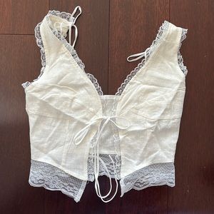 White tie up top at front. Adjustable straps. Size XS